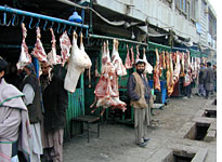 Food refrigeration and sanitation aren't up to normal health standards; this is Butchery Street in Kabul