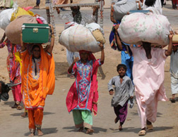 Women carrying parcels on their heads. Click image to expand.