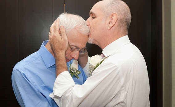 Same-sex couple Frank Faria and Randy Faria (R) kiss as they wed during the first day of legal same-sex marriage in New York State on July 24, 2011 in New York City.