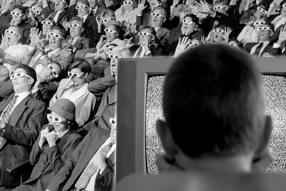 Audience in a movie theater, boy watching TV.