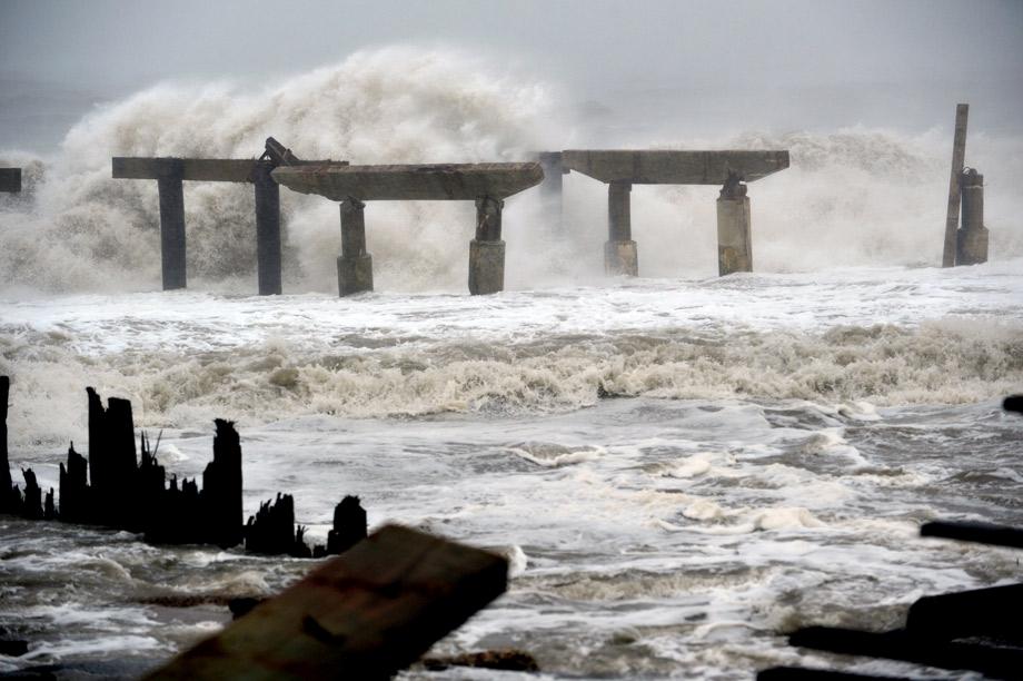 Waves crash against a previously damaged pier before landfall of Hurricane Sandy on Monday in Atlantic City, New Jersey. 