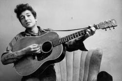 Bob Dylan poses for a portraitwith his Gibson Acoustic guitar in September 1961 in New York City, New York.