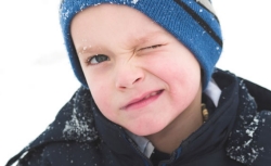 little boy staring at the snow
