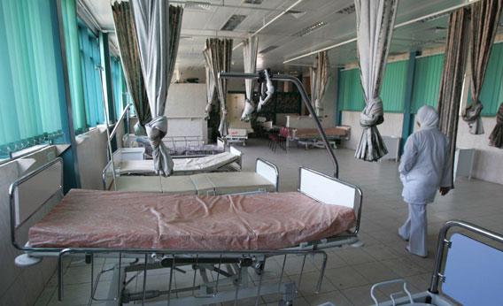 A nurse walks past empty beds at the government run hospital in the northern West Bank city of Jenin 20 November 2006. 