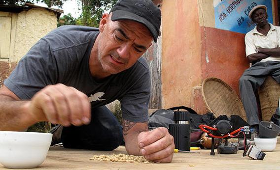 Todd Carmichael inspects the coffee beans as a local man looks on in Haiti on 'Dangerous Grounds.'