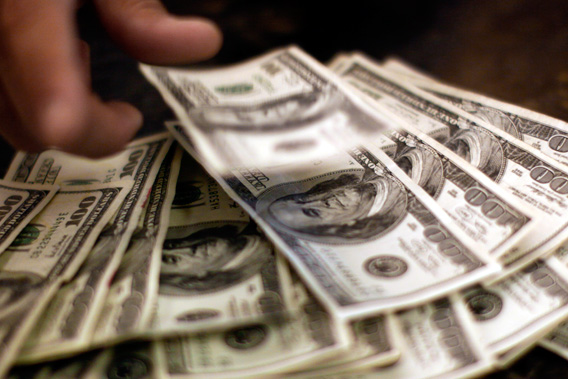 Four thousand U.S. dollars are counted out by a banker counting currency at a bank in Westminster, Colo., Nov. 3, 2009.