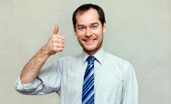 Smiling Young Office Worker Showing Thumbs UP Sign