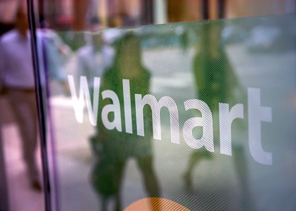 The Walmart logo is displayed in the window of a Walmart Neighborhood Market store on August 15, 2013 in Chicago, Illinois.