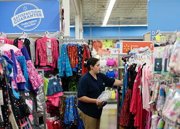 A worker stocks merchandise at a Walmart Supercenter in Los Angeles in 2013.