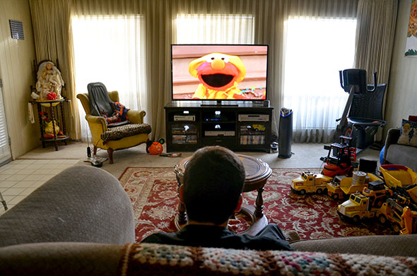 Mark watches Sesame Street, one of his favorite TV shows.