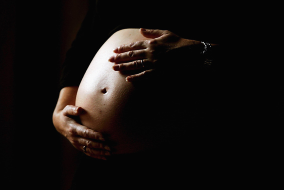 A pregnant woman holds her stomach June 7, 2006 in Sydney, Australia.