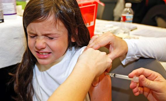 A nurse gives a shot of the H1N1 vaccine.