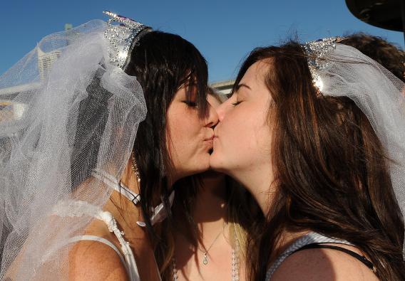 89548583 Loren Cowley, left, and Michelle Ricketts seal their vows with a kiss outside the ruling Labor Party's conference during a mass 'illegal wedding'.