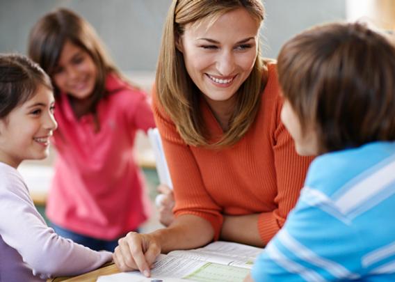 Teacher Assisting Group of Students