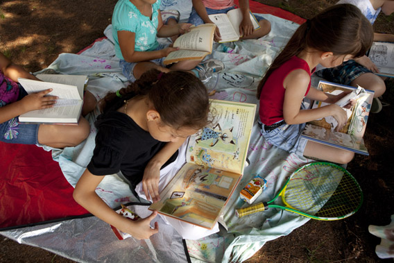Children in summer camp read books during a literacy session August 18, 2011 in Jamaica Plain, Massachusetts.
