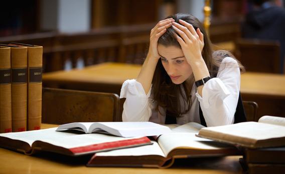 Overloaded student in library.