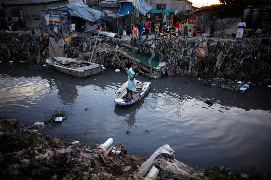 A resident crosses a dirty drain, which leads into the sea at downtown Port-au-Prince, Oct. 29, 2010. The unusually high death rate in Haiti's cholera epidemic is slowing as people become aware of the disease and health experts provide treatment, the World Health Organization said on Wednesday. The United Nations agency's key aim now is to prevent the disease from spreading south to the capital, Port-au-Prince, and the camps for homeless survivors of the Jan. 12 earthquake, from the northern department of Artibonite where it is concentrated.