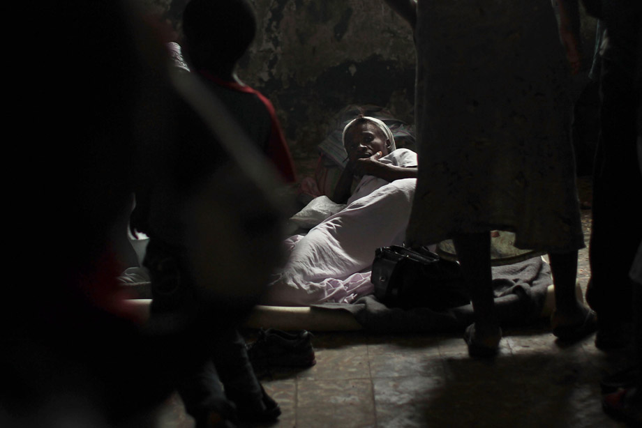 A family lives in a room on the grounds of an abandoned hospital where they and hundreds of others had been evacuated from the Corail-Cesselesse relocation camp, due to Hurricane Tomas Nov. 5, 2010, in Port-au-Prince, Haiti. The storm, which caused some flooding and heavy rains, largely spared Haiti.