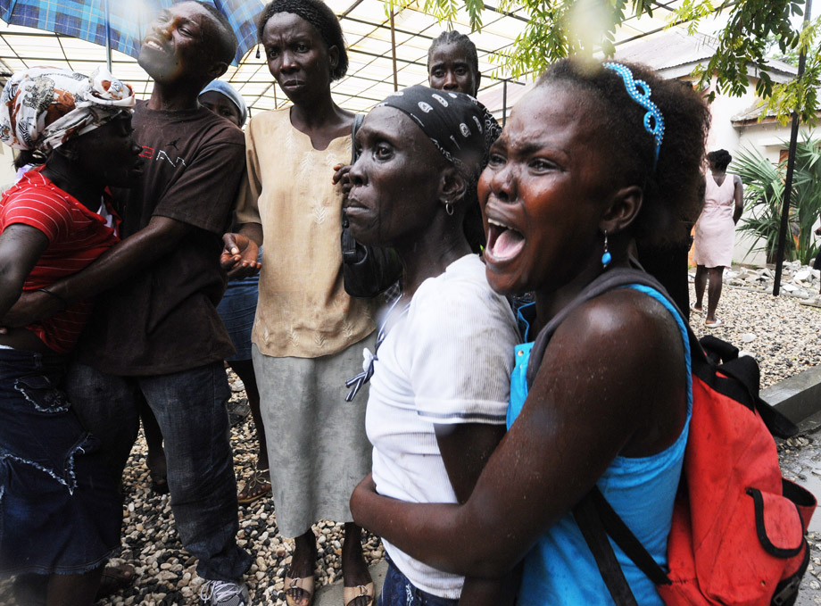 Patients and families wait outside at St. Nicolas Hospital on October 21, 2010 in St. Marc, 96 Km in the north of Port-au-Prince, amid a cholera epidemic.