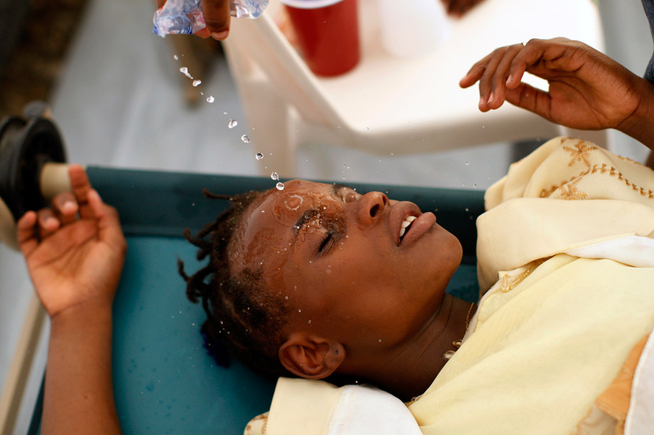 A Haitian girl with cholera symptoms is doused with water at an improvised clinic run by Doctors Without Borders in Port-au-Prince, Nov. 20, 2010. 
