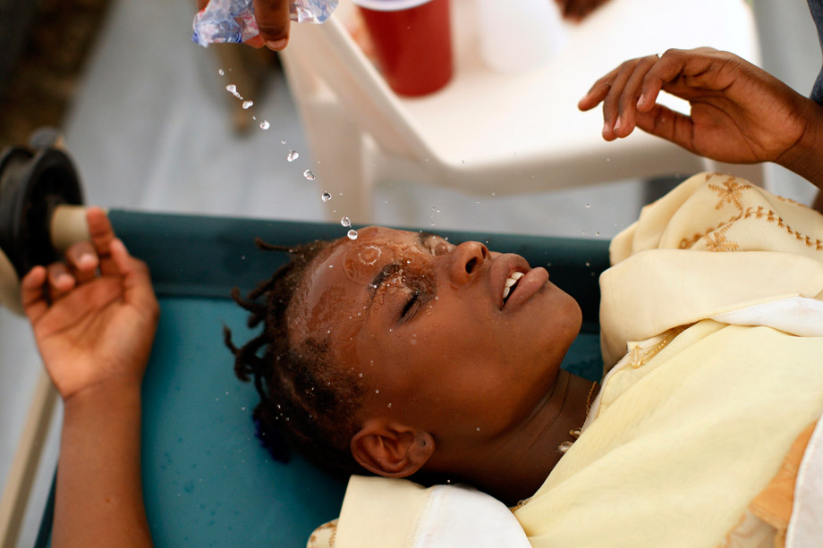 130225_FOR_cholera13 A Haitian girl with cholera symptoms is doused with water at an improvised clinic run by Doctors Without Borders in Port-au-Prince, Nov. 20, 2010.