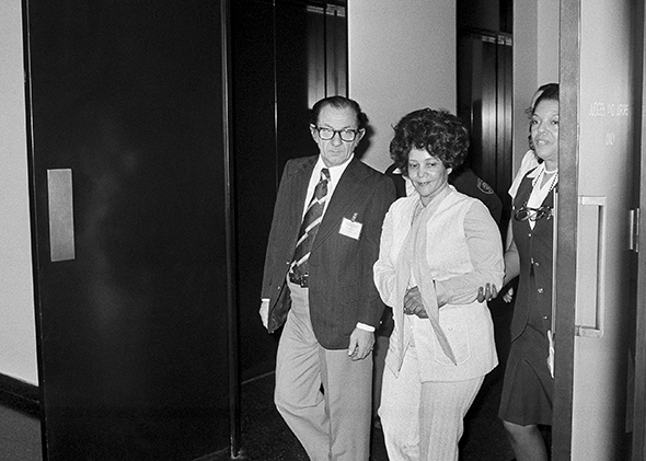 Linda Taylor, 40, walks with her attorney T. Lee Boyd as they leave the Chicago Civic Center Tuesday, March 8, 1977 during a recess in her trial.