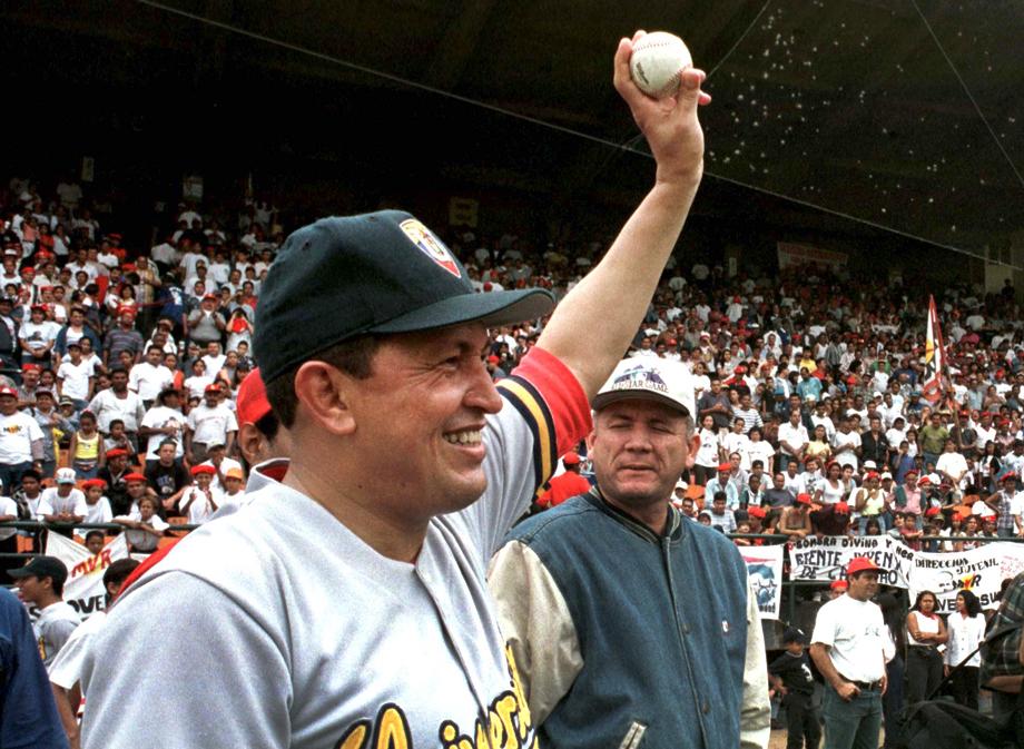 Venezuela's leading presidential candidate Hugo Chavez waves to crowds after playing baseball in a friendly match with Venezuelan show business personalities at the University Stadium in Caracas on October 4.  TA/KM - RTRXMJG