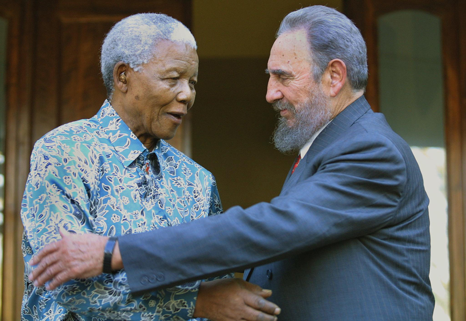 Former South African president Nelson Mandela hugs Cuban president Fidel Castro at Mandela's office in Johannesburg 02 September 2001. Castro who took part in the UN World Racism conference in Durban used the opportunity to visit Mandela, whose health is effected by cancer.       