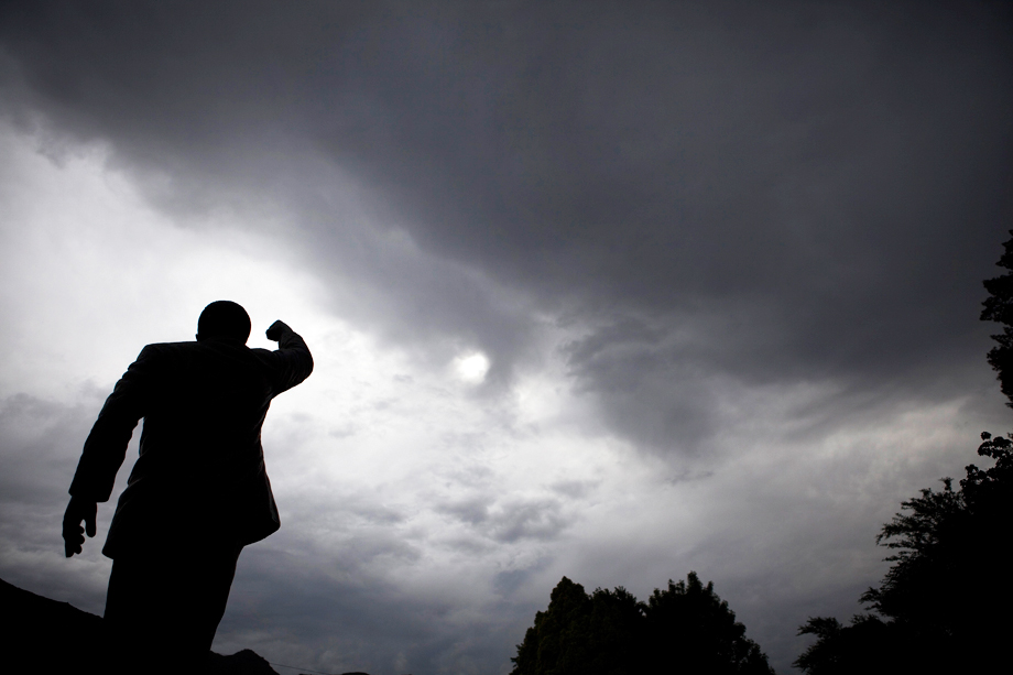Storm clouds gather above a statue of Nelson Mandela outside the gates of Drakenstein Correctional Centre (formerly Victor Verster Prison), near Paarl in Western Cape province February 10, 2010. 