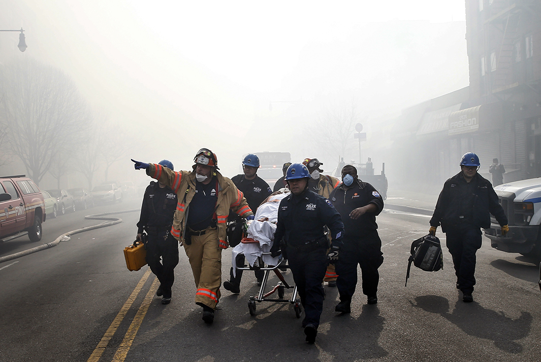 A victim is evacuated by emergency personnel. 