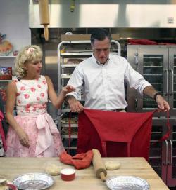 Mitt Romney puts on a apron as Sweetie-licious Bakery Café store owner.