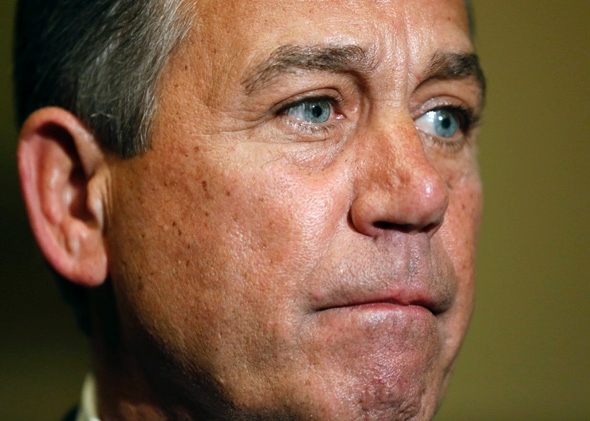 Speaker of the House John Boehner pauses as he speaks to the media after 1:00 am, after the House of Representatives voted to send their funding bill with delays to the &quot;Obamacare&quot; health care act into a conference with the Senate, prompting a shutdown of portions of the U.S. government.