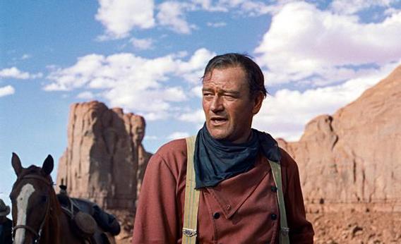 John Wayne plays Ethan Edwards in the 1956 film &quot;The Searchers.&quot;  Director John Ford and frequent leading man Wayne forged one of Hollywood's most enduring partnerships.  