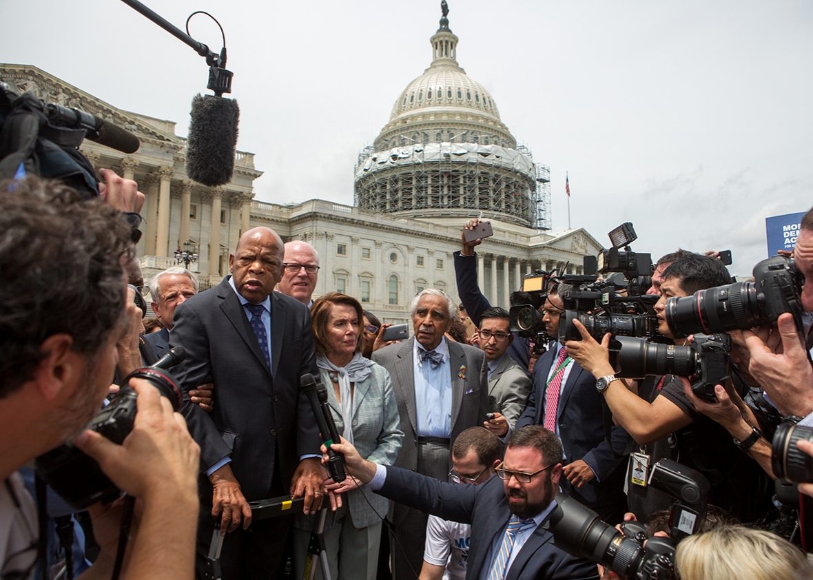 Rep. John Lewis, left, Minority Leader Nancy Pelosi, center, and Charles Rangel, right, speak with supporters outside the U.S. Capitol building June 23, 2016 in Washington, DC. 