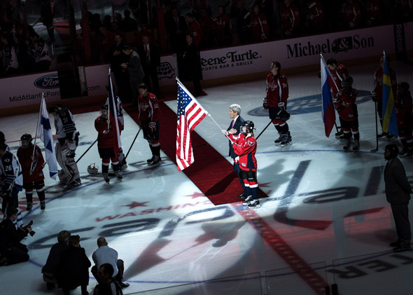 US Secretary of State John Kerry listens to the US National Anthem before a hockey game at the Verizon Center 6, 2014 in Washington, DC.  