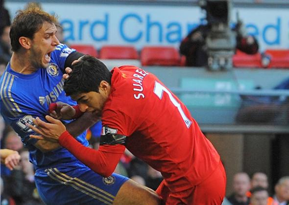 Liverpool's Uruguayan striker Luis Suarez (R) clashes with Chelsea's Serbian defender Branislav Ivanovic (L).