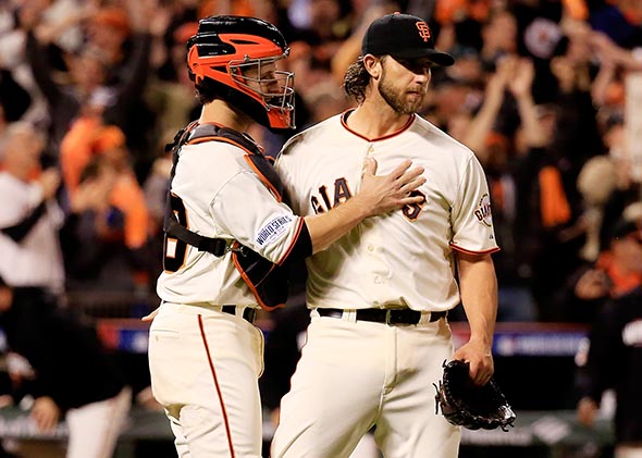 Madison Bumgarner #40 celebrates with Buster Posey #28 of the San Francisco Giants after defeating the Kansas City Royals 5-0 in Game Five of the 2014 World Series.