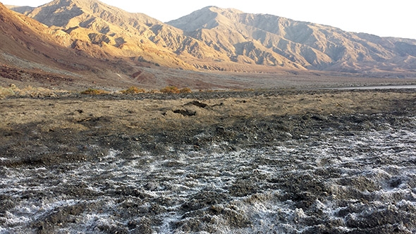 Tiny salt crystals cover Badwater Basin in Death Valley, the lowest, hottest, and driest point in North America. Surprisingly, the ground here is actually moist underfoot.