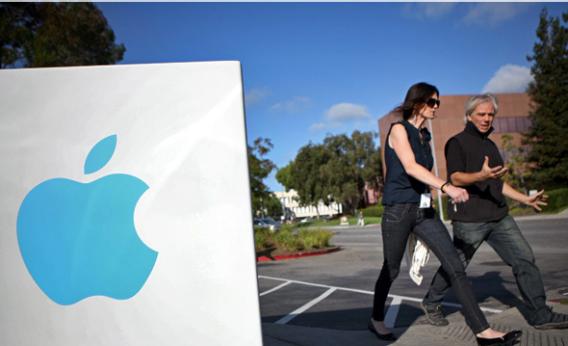 Apple employees walk towards the Apple Headquarters to attend Apple co-founder Steve Jobs' memorial service in Cupertino, California, on October 19, 2011.