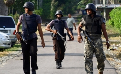 Anti terror police patrol in Setosa village as they search for Islamic militants who escaped into the jungle in Aceh Besar in Indonesia's Aceh province March 10, 2010.