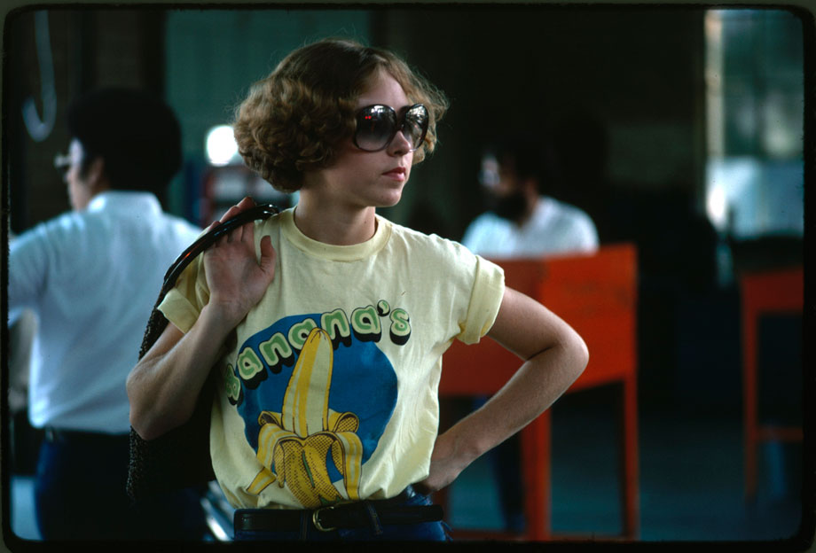 Photograph, "“Young woman watches as her car goes through testing at an auto emission inspection station in Downtown Cincinnati, Ohio.  All light duty, spark ignition powered motor vehicles are tested annually for carbon monoxide and hydrocarbon emissions, and given a safety check.  All other vehicles registered in the city receive an annual safety check.  The emissions test on an exhaust analyzer went into effect in January 1975; the safety test has been in effect since 1940”, September 1975Photographer: Series: Photographs and other Graphic Materials from the Environmental Protection Agency, (12/09/1970-)Record Group 412: Records of the Environmental Protection Agency, 1944-2006Still Pictures Identifier: 412-DA-13704ARC Identifier: 556156Rediscovery Identifier: 25280