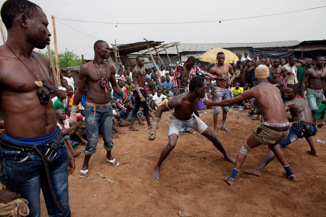 17 Lagos, Nigeria- A match between two fighters is stopped by another boxer in Lagos, Nigeria. Each match consists of three rounds. The match is stopped if a boxer's "spear" becomes unraveled or if one boxer hits the ground.