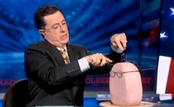 Stephen Colberts eats a ham loaf dressed up as Karl Rove in a still from 'The Colbert Report'.