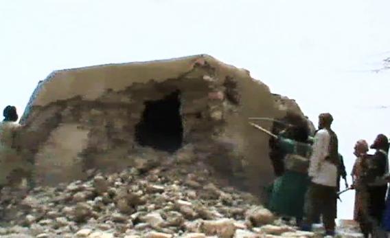 147635308 A still from a video shows Islamist militants destroying an ancient shrine in Timbuktu.