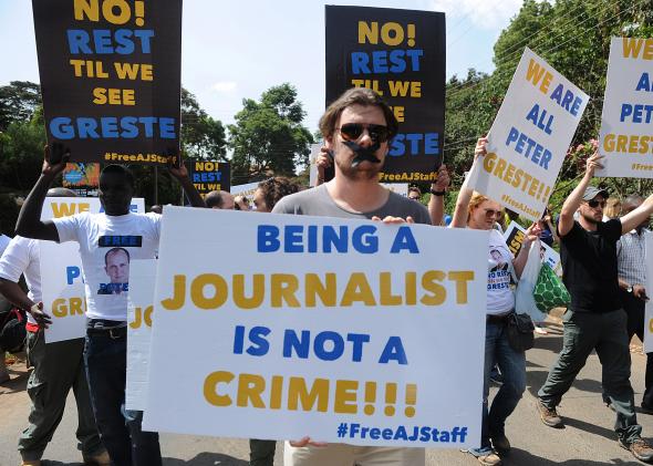 466799149-foreign-journalists-hold-banners-as-they-march-to-the