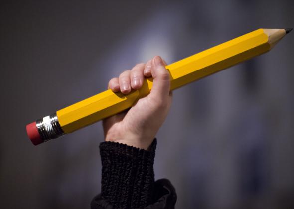 461237090-giant-pencil-is-held-up-at-a-vigil-outside-the-french