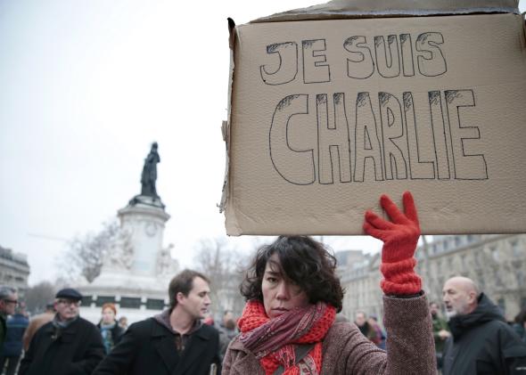 461124990-woman-holds-up-a-placard-that-reads-in-french-i-am