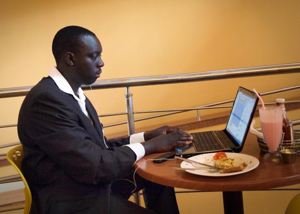 A man works on his laptop at an Internet cafe in Kampala, Uganda, on Nov. 11, 2011. 