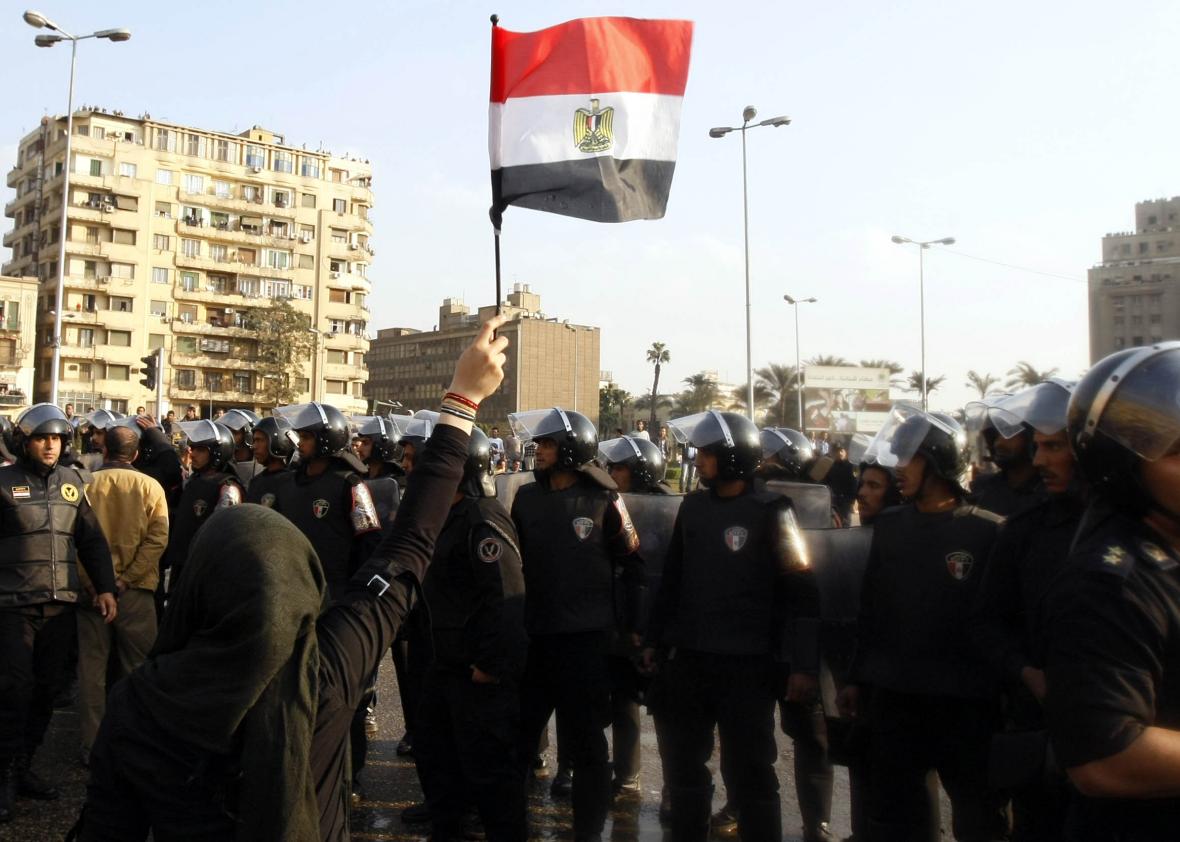 108307822-an-egyptian-demonstrator-holds-up-her-national-flag