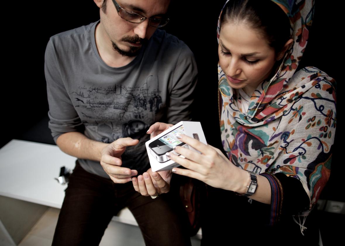 169937016-an-iranian-couple-inpect-the-box-of-an-iphone-they-just